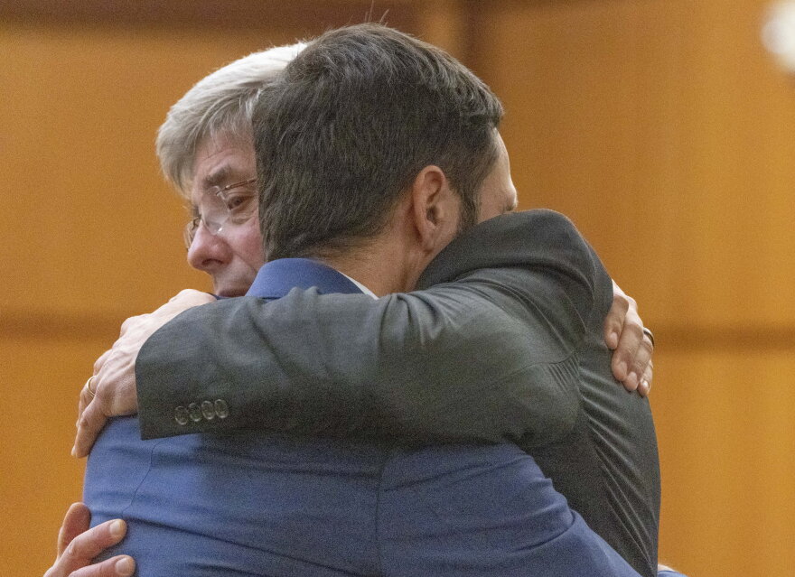 Tacoma Police officer Christopher ÒShaneÓ Burbank gets a hug from his attorney Wayne Fricke after he is declared not guilty for any charges related to the March 2020 killing of Manny Ellis in Pierce County Superior Court in Tacoma Thursday, December 21, 2023. Officers Matthew Collins and Timothy Rankine were both declared not guilty for all charges regarding his death.