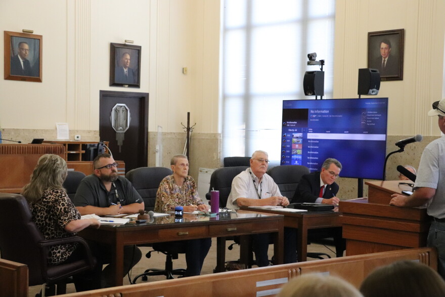 (From left to right) Grady County Commissioners Zachary Davis, Ruth Bingham and Gary Bray sit next to Grady County District Attorney Jason Hicks at a meeting on September 8.