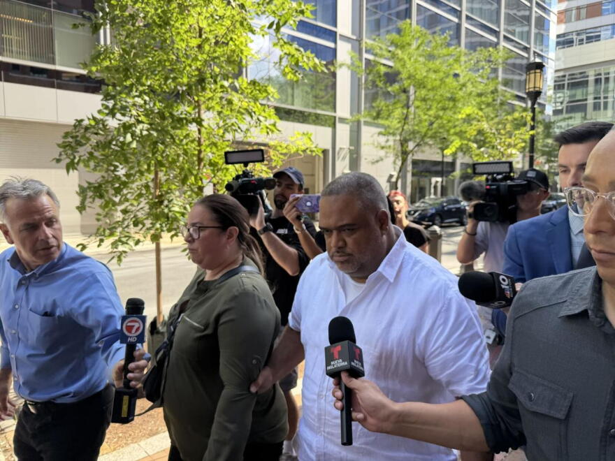 After being arraigned on 11 federal charges, Rep. Francisco Paulino of Methuen walks away from the Moakley Courthouse in Boston on Aug. 26, 2026, as members of the press ask him questions.