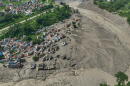 Damaged houses stand precariously near the swollen, debris-choked banks of the Trishuli River after flash floods in Nepal's Nuwakot district on Wednesday, Aug. 26, 2026. (Niranjan Shrestha/AP)