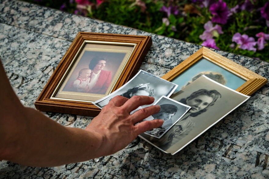 Cara Despain looks through family photos of her mother Bonnie, Aug. 26, 2026. A bone fragment sent in for testing after Despain’s mother died has spurred a new study to further examine the long-term effects radiation has on the human body.