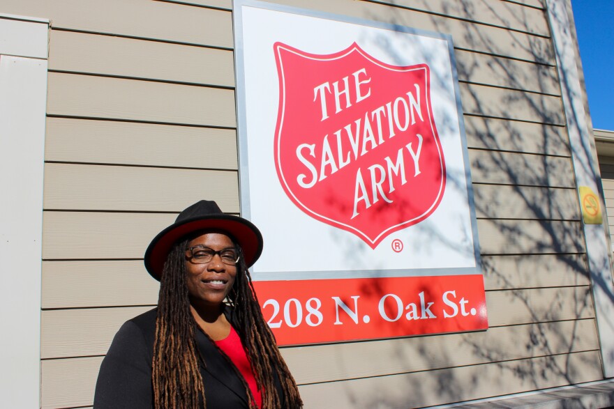 Salvation Army Safe Harbor Residential Services Director Gaynett Hoskins outside of the Safe Harbor Facility. She's next to a sign for Salvation Army with the building address. 