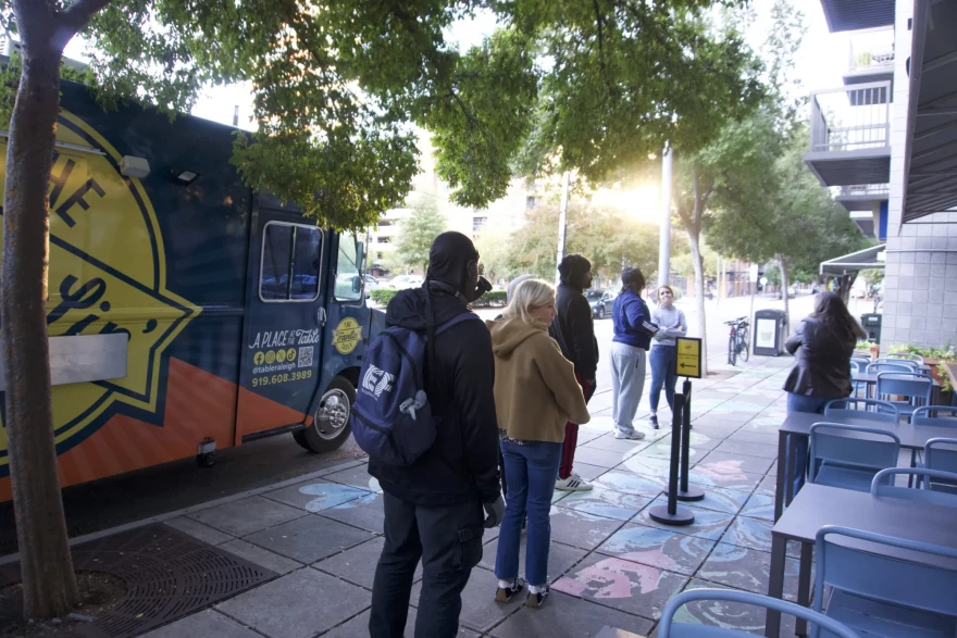 Volunteers gather outside of A Place at the Table in downtown Raleigh. The cafe is Raleigh's first pay-what-you-can cafe.
