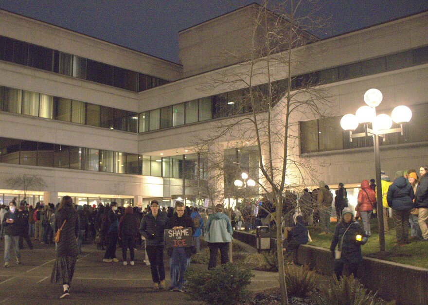 person holds sign up to window