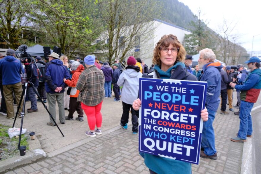 Juneau resident Lynn Hershey stands with a sign at a rally in support of Mary Peltola for U.S. Senate on May 14, 2026.