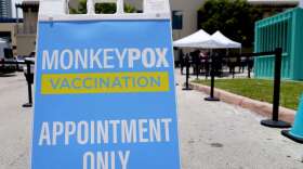 A sign for monkeypox vaccinations is shown at a vaccination site, Wednesday, Aug. 10, 2022, in Miami Beach, Fla. Miami-Dade County, in partnership with Nomi Health, will begin offering monkeypox vaccinations to eligible, high-risk residents on Friday. U.S. health officials on Tuesday authorized a plan to stretch the nation's limited supply of monkeypox vaccine by giving people just one-fifth the usual dose, citing research suggesting that the reduced amount is about as effective. (AP Photo/Lynne Sladky)