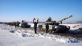 In this photo taken from video provided by the Russian Defense Ministry Press Service on Feb. 15, 2022, Russian army tanks stand ready to move back to their permanent base after drills in Russia. (Russian Defense Ministry Press Service via AP)