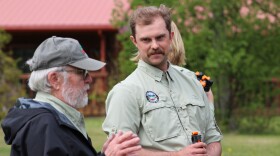 Stream Watch Coordinator Chris Haberbush listens to a volunteer speak during a bear spray demonstration on Saturday, June 6, 2026 in Cooper Landing, Alaska.