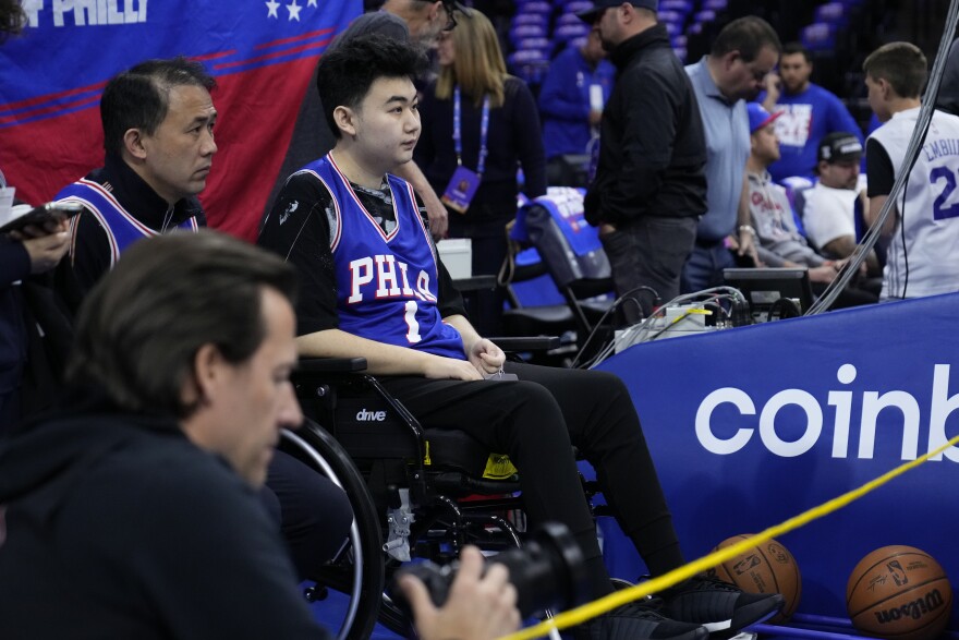 John Hao, second from left, watches warm ups ahead of Game 4 in an NBA basketball Eastern Conference semifinals playoff series between the Philadelphia 76ers and the Boston Celtics, Sunday, May 7, 2023, in Philadelphia.