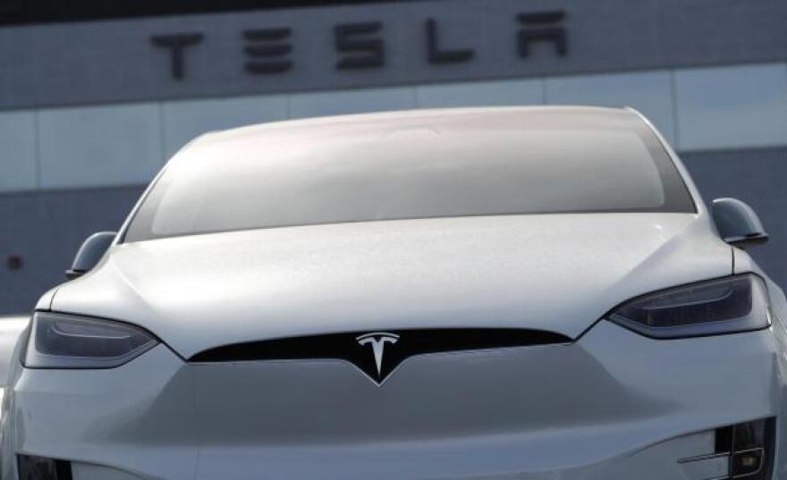 In this April 15, 2018, file photo, an unsold 2018 Model X 100d sits on a Tesla dealer's lot in the south Denver suburb of Littleton, Colo.