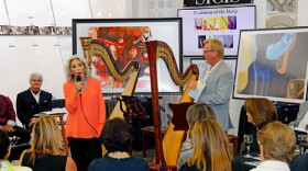 At a recent 'art salon,' Venetian Arts Society Board Member Anna Rua (L) addresses the attendees while Executive Director William Riddle (R) looks on. Fun fact: Rua is the aunt of actor Sylvester Stallone.