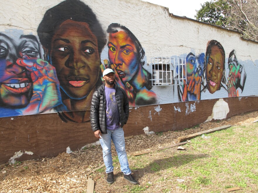 Atlanta artist Fabian Williams is painting a mural on the side of Marddy's. He says it's about younger generations listening to their ancestors.