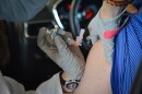 A person gets their flu shot at a vaccine drive-thru in the Kansas City area last month. Drive-thrus like this are a popular way to get a flu shot amid the coronavirus pandemic.