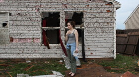 Lauren Gardner stands near a family members house, which was destroyed by the tornado.
