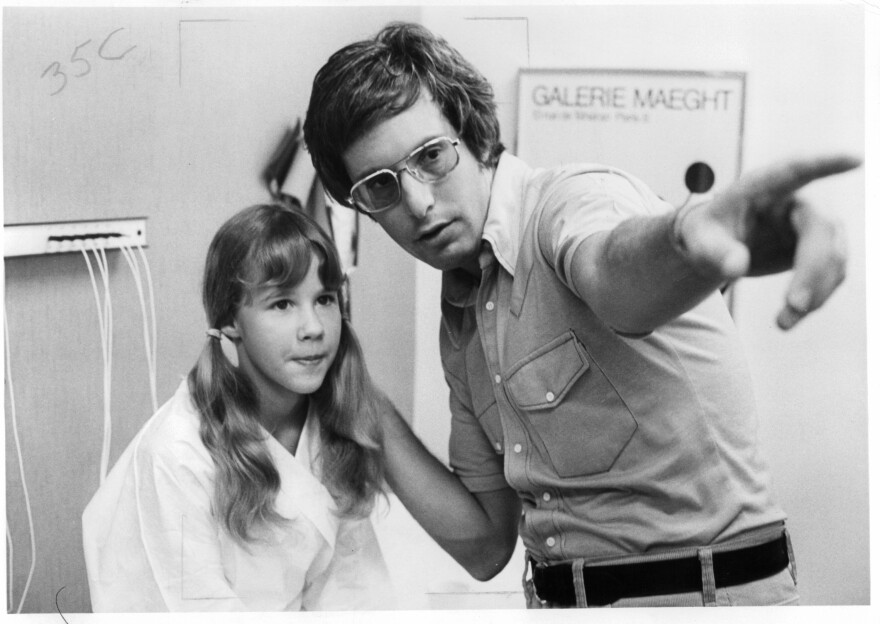 Friedkin gives direction to 12-year-old actress Linda Blair, who played the possessed Regan MacNeil, on the set of <em>The Exorcist</em>.