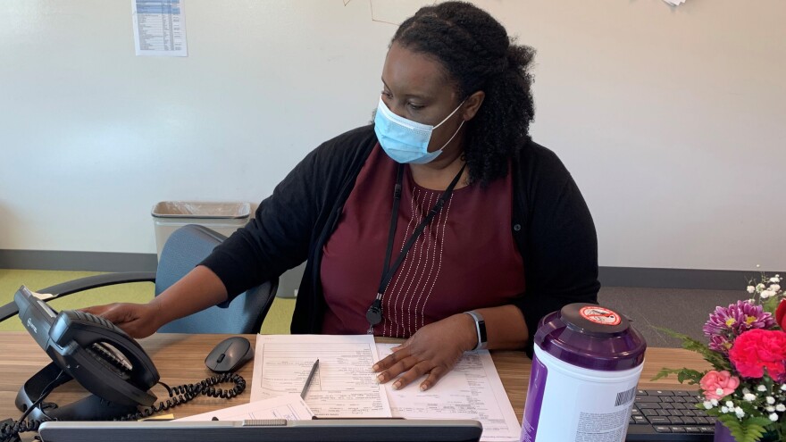 Dr. Amina Egwiekhor, a consulting physician at the Cuyahoga County Board of Health, prepares to make a contact tracing call on August 12, 2020. The county is ramping up its contact tracing efforts now that some schools have reopened. [Anna Huntsman / ideastream]