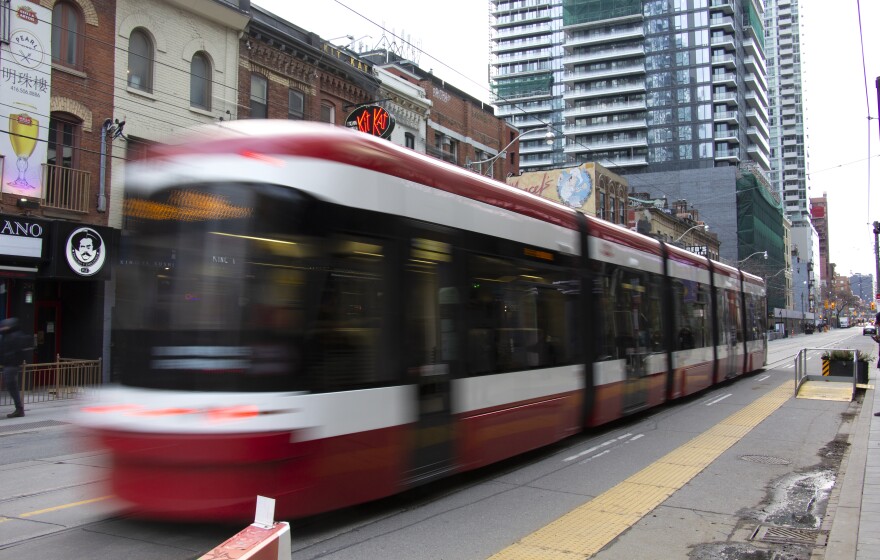 A streetcar rolls down King Street in downtown Toronto. Most car traffic has been diverted from this section of the street.