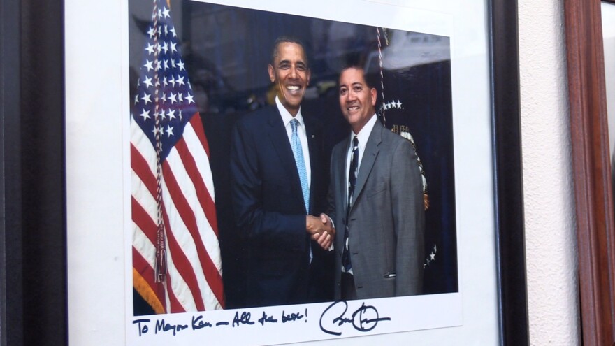 A framed and signed picture of Miyagishima shaking hands with former president Barack Obama.