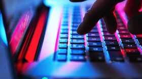 A young adult using a laptop. (Getty Images)