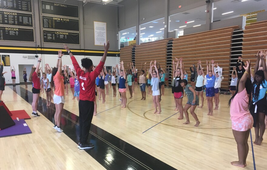 Girls work on gymnastics skills at Camp WIN this week in Kansas City, Missouri. The national gymnastics championships will be held at Sprint Center later this summer.