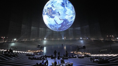 Visitors watching the earth at the exhibition "The Fragile Paradise" at the Gasometer in Oberhausen, Germany, Tuesday, May 23, 2023.