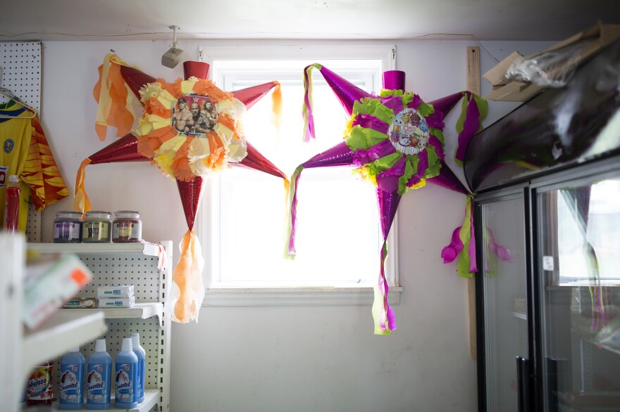 Piñatas hang in the window at the store that Fabiola Escamilla owns in Galax, Va.