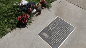 In this July 25, 2019, photo, flowers and other items lay near a memorial plaque in the sidewalk near the spot where Michael Brown was shot and killed by a police officer five years ago in Ferguson, Mo. (Jeff Roberson/AP)