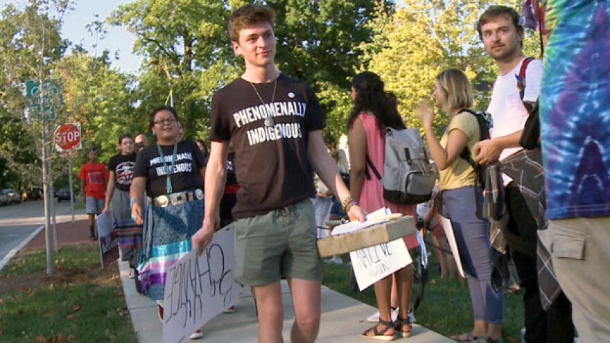 Organizer Caleb King leads the march to the county courthouse.