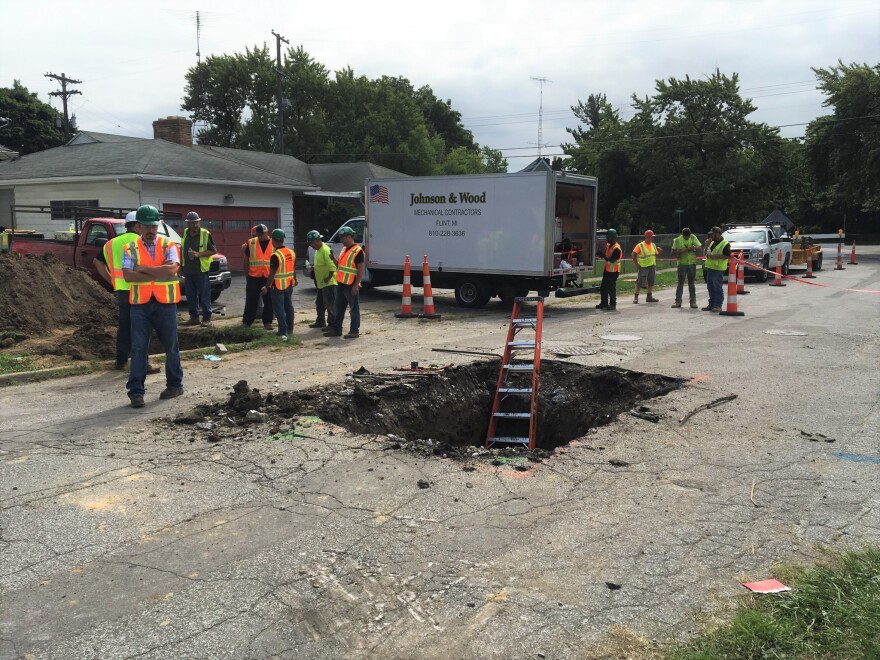 construction crew at hole in the road