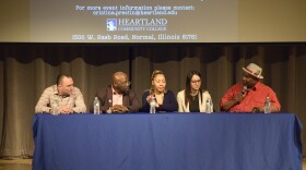 Five panelists on stage at an event