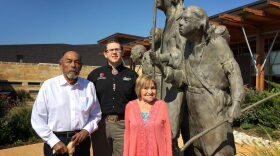 Chickasaw tribal elders Jerry Imotichey (left) and Hannah Pitmon (right) stand with Joshua Hinson (middle), director of the Department of Chickasaw Language, in front of "The Arrival" statue at the Chickasaw Cultural Center in Sulphur, Okla. 
