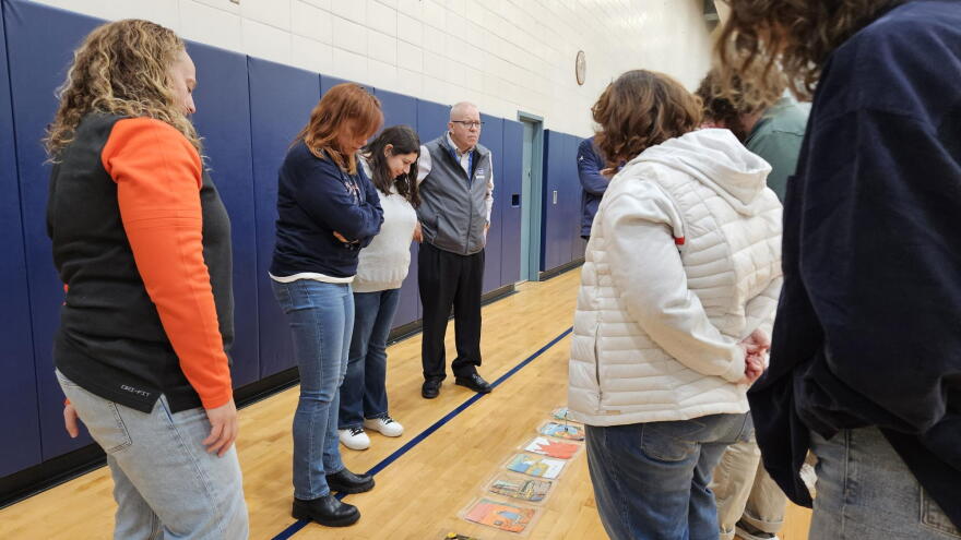 High school teachers from schools in the Buffalo area arrange pictures for a group activity during a leadership conference Oct. 19 at Villa Maria College.