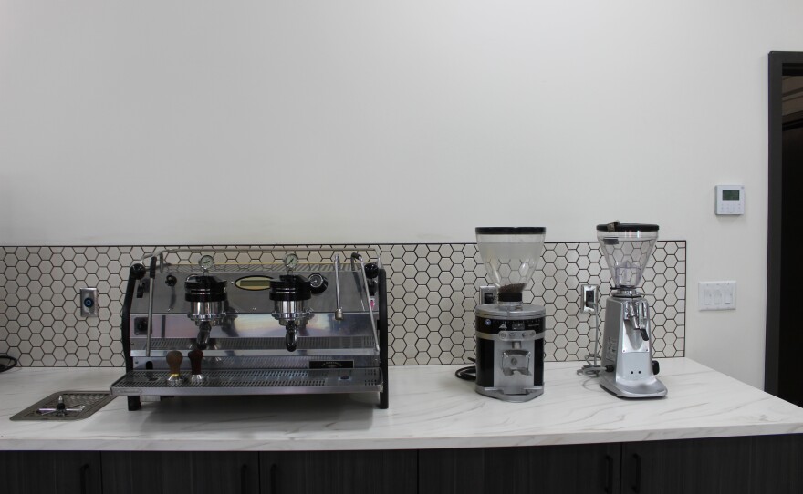 The front room at Bonfire Coffee's new roastery boasts coffee gear, apparel, and equipment, as well as a small office.