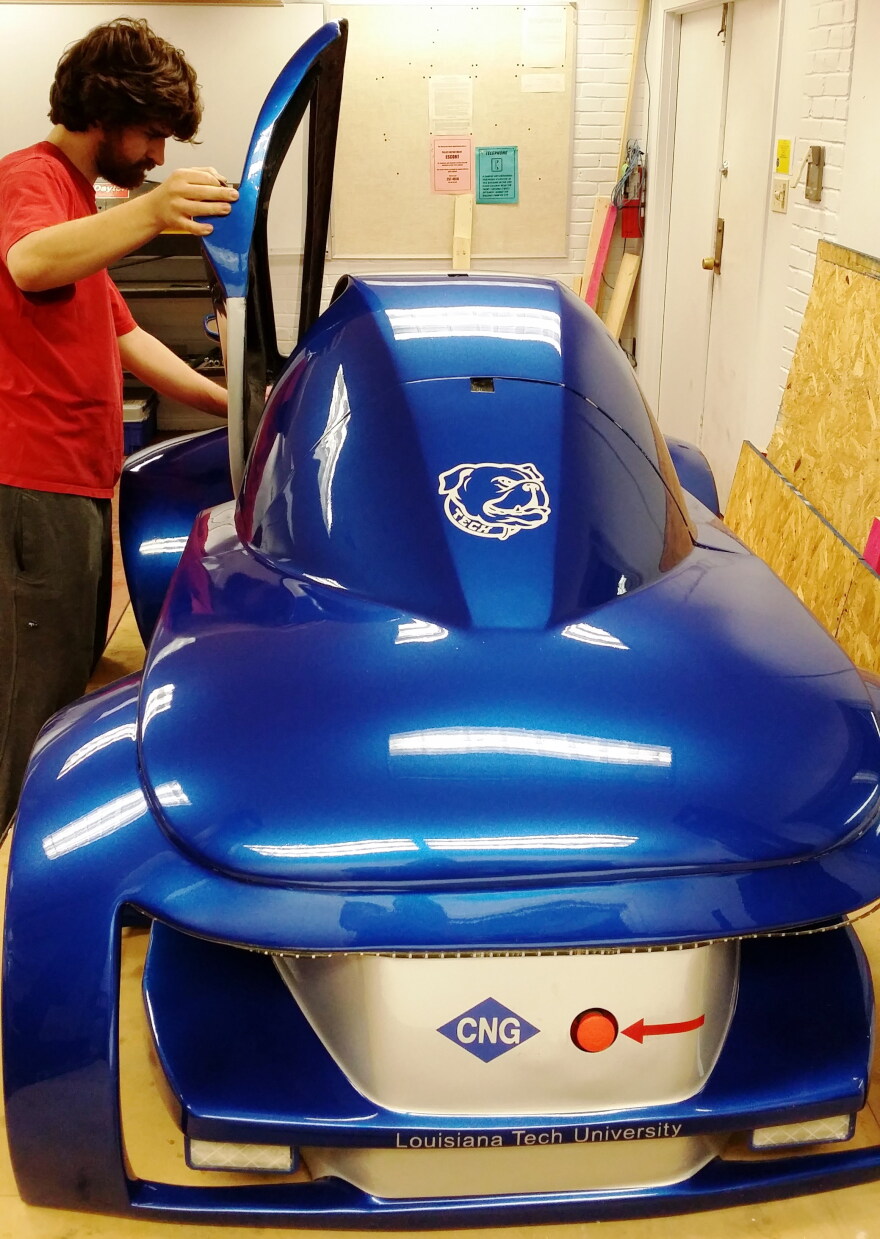 Louisiana Tech mechanical engineering junior Timothy Parker of Mandeville, La., helps to put the finishing touches on a compressed natural gas vehicle that will compete in the urban concept category.