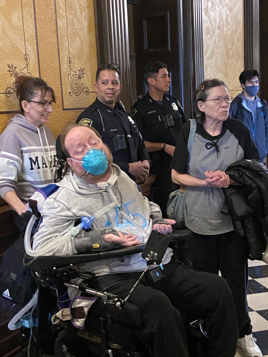 People severely injured in car crashes and relatives stand outside House Speaker Jason Wentworth's office after being told he would not meet with them.