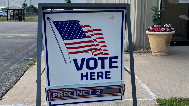 A sign reading "vote here" directs people to Blair Township's Precinct Number 2, on August 2, 2022.