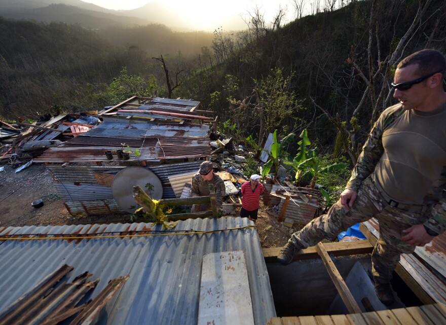 Santini (right) and <strong></strong>Sgt. Kenneth<strong> </strong>McAnally with troops and volunteers from the Crisis Relief Team repair Ruben Caraballos' leaking roof in Utuado.