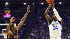 Kentucky's Chris Livingston (24) shoots while defended by Florida's Kowacie Reeves (14) during the first half of an NCAA college basketball game in Lexington, Ky., Saturday, Feb. 4, 2023. (AP Photo/James Crisp)