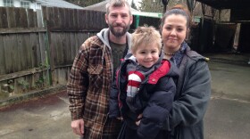 Larry Jametsky, Christina Stewart and their son Lawrence outside the home they say they lost in a fraudulent loan deal in Feb. 2014.