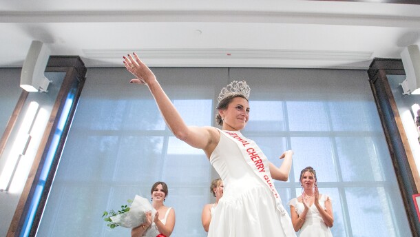 Magdalen Kleinrichert reacts after being crowned the 2026-27 National Cherry Queen by outgoing queen Ainslee Hewitt during Friday’s National Cherry Festival Queen’s Coronation at the Park Place Hotel in Traverse City.