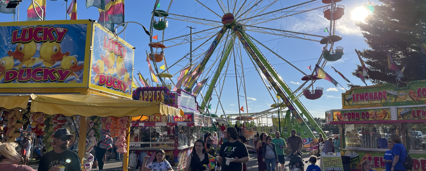 Attendees enjoy a sunny evening at the Northwest Michigan Fair on Aug. 10, 2023. (Photo: Izzy Ross/IPR)