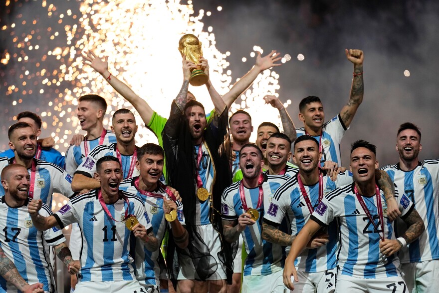 Argentina's Lionel Messi lifts the trophy after winning the World Cup final soccer match between Argentina and France at the Lusail Stadium in Lusail, Qatar, on Dec. 18, 2022.