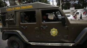 Guatemalan military vehicles surround the anti-corruption mission in Guatemala City on Friday.