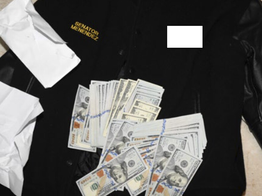 This photo, which was included in an indictment of U.S. Sen. Bob Menendez (D-N.J.), shows a jacket bearing Menendez's name, along with cash from envelops found inside the jacket during a search by federal agents of the senator's home in Harrison, N.J., in 2022.