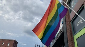 A pride flag over a street in North Topeka. 
