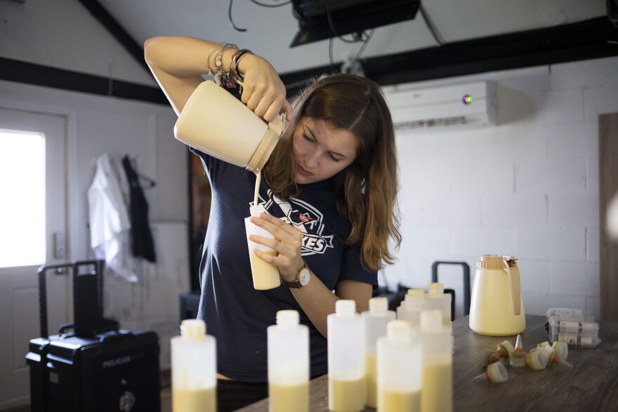 Dana Baldus pours pancake batter before mixing it with dye to create a "ROYGBIV" color palette. 