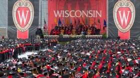 FILE - Graduates listen to the commencement address during graduation at the University of Wisconsin in Madison, Wis., May 12, 2018. (AP Photo/Jon Elswick, File)