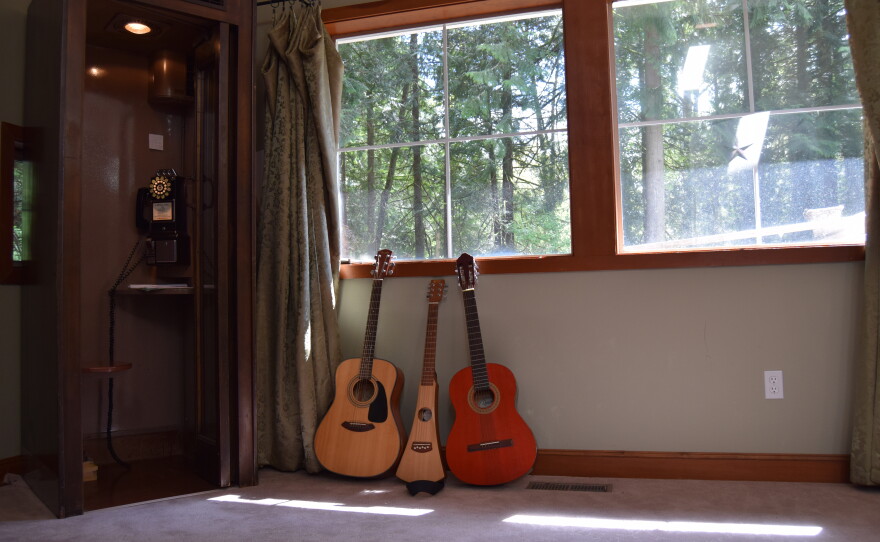The front room of the main house at reSTART, an inpatient digital recovery treatment facility, has guitars leaning against a rotary phone, which clients can use to call out.