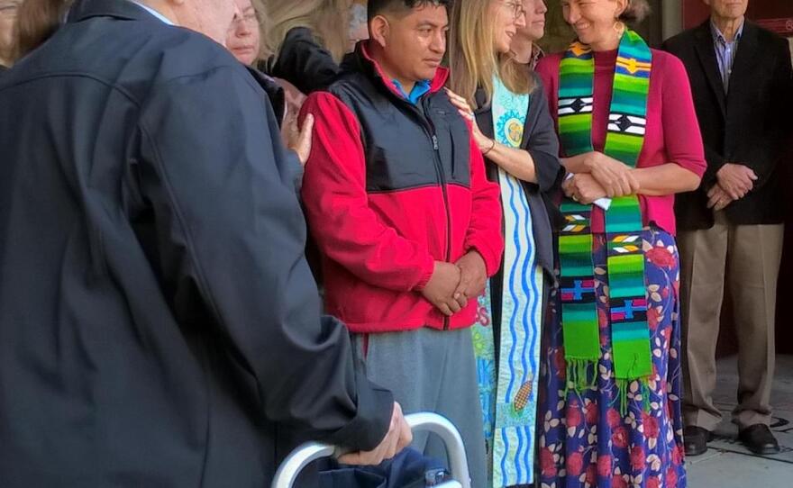 Lucio Perez, center, in a red jacket, is surrounded by local clergy in front of the First Congregational Church in Amherst, Massachusetts, in October 2017 when he entered sanctuary.