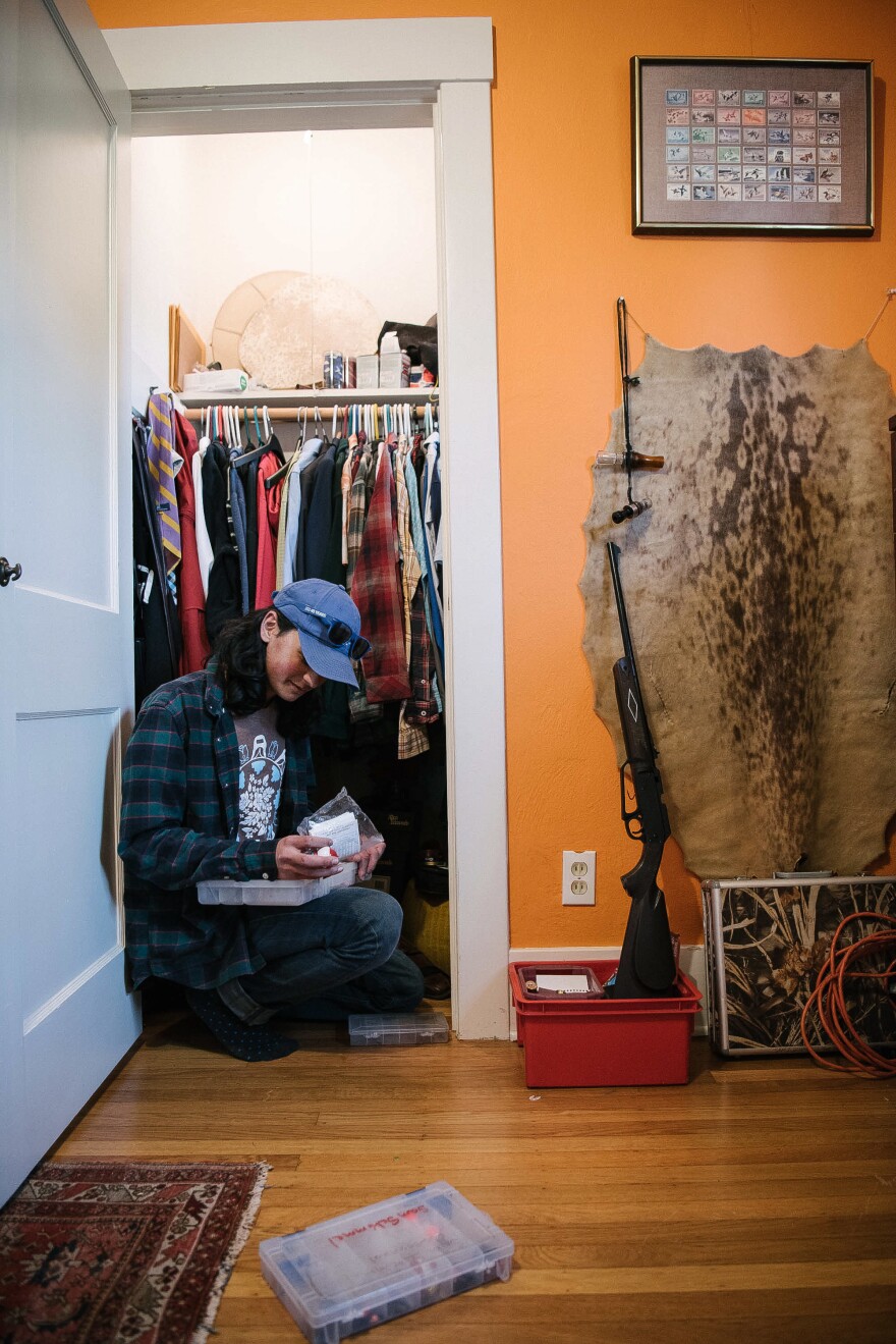 Sam Schimmel prepares fishing gear at his home. An accomplished fisherman and competitive shooter, he learned traditional Arctic subsistence hunting techniques from relatives in Alaska.